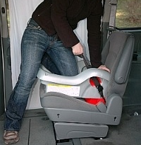 car seat installation putting knee in seat to use body weight