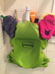 Little Miss bath mitt puppet washcloths by Roger Hargreaves hanging to dry on feet of Boon Frog bath pod