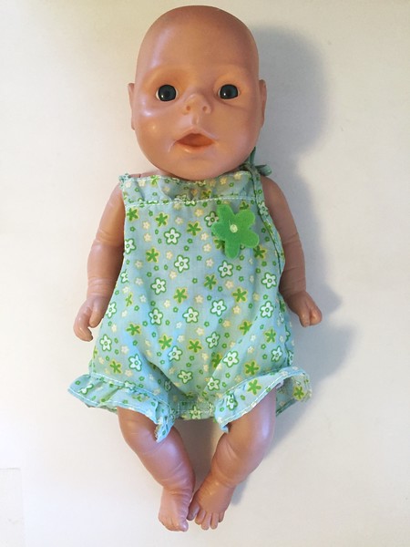 Hard baby doll wearing Baby Stella doll clothes by Manhattan Toy outfit