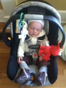 Infant in infant car seat on floor