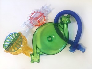 Q-BA-MAZE stunt expansion set pieces including two blue tubes, a spinner, a catcher, and a funnel