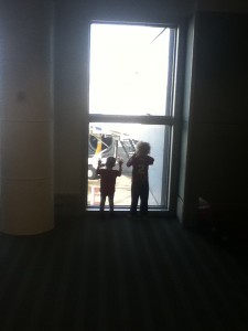 Kids silhouetted by window at airport
