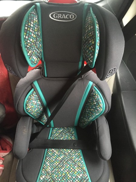 Graco TurboBooster highback booster seat installed in car with seat belt fastened