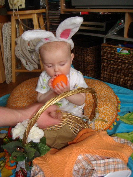 Baby chewing on jumbo plastic easter egg