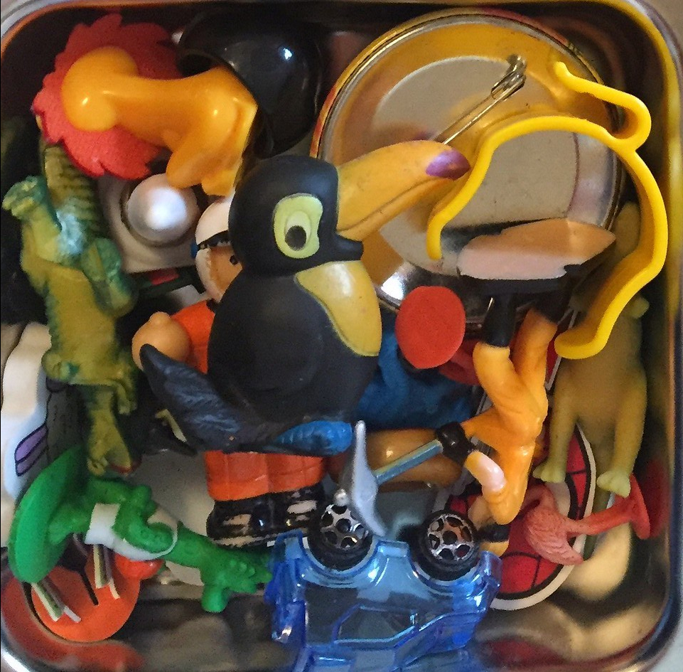 Tiny toys choking hazard stored in pile inside divided lunch box