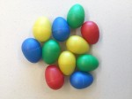 musical egg shakers in blue red green and yellow in pile