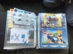 Lego instruction manuals stored in page protectors inside three ring binder