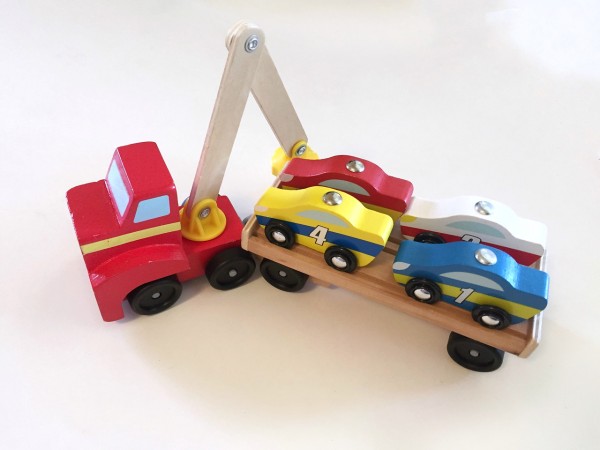 Melissa and Doug wooden car loaded with four car loaded onto flatbed