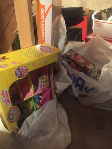 Toys in bags stored inside unfinished closet storage space