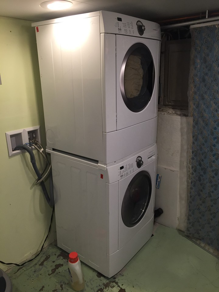Frigidaire stacking washer dryer combo installed in basement laundry area