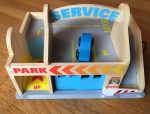 Melissa and Doug Parking Garage Service Station wooden toy set with blue car parked on top deck