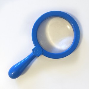 Blue kids magnifying glass on white surface