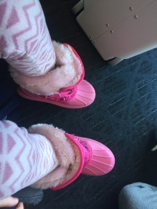 Kids snow boots CG pink Velcro boots with fake pale pink fur trim at top in airport next to Jetkids BedBox