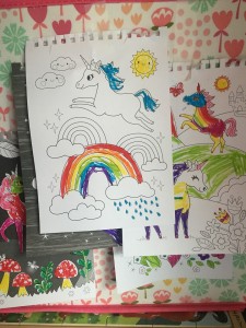 Unicorn magic coloring pages hung up as decorations in child's room