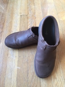 Merrrell Women's Encore Kassie Buckle Slide Clog shoe in brown on wooden floor
