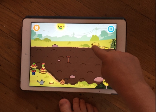 Child watering seeds in Toca Life Farm app on iPad device screenshot