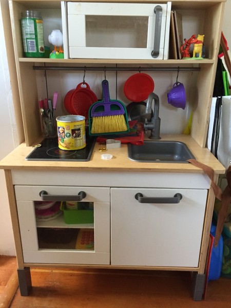 IKEA toy play kitchen with accessories hung