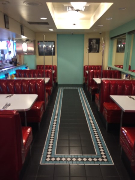 Diner in San Francisco shiny red booth and tile floor restaurant
