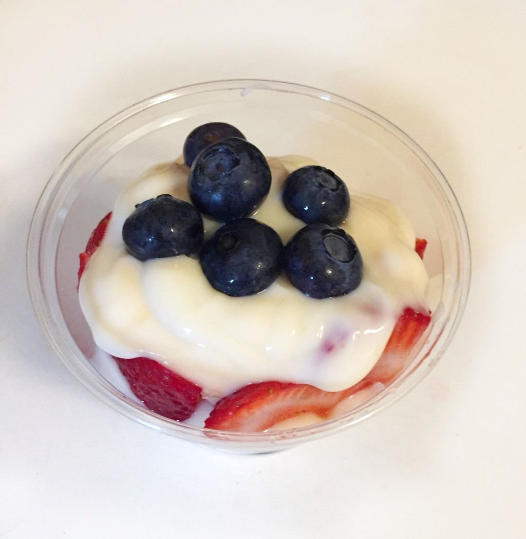 Blueberries and strawberries with yogurt in clear cup