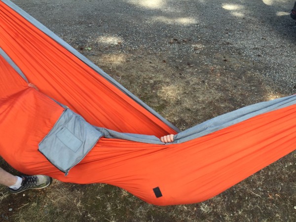 Eagles Nest Outfitters ENO orange hammock with tiny hand peeking out
