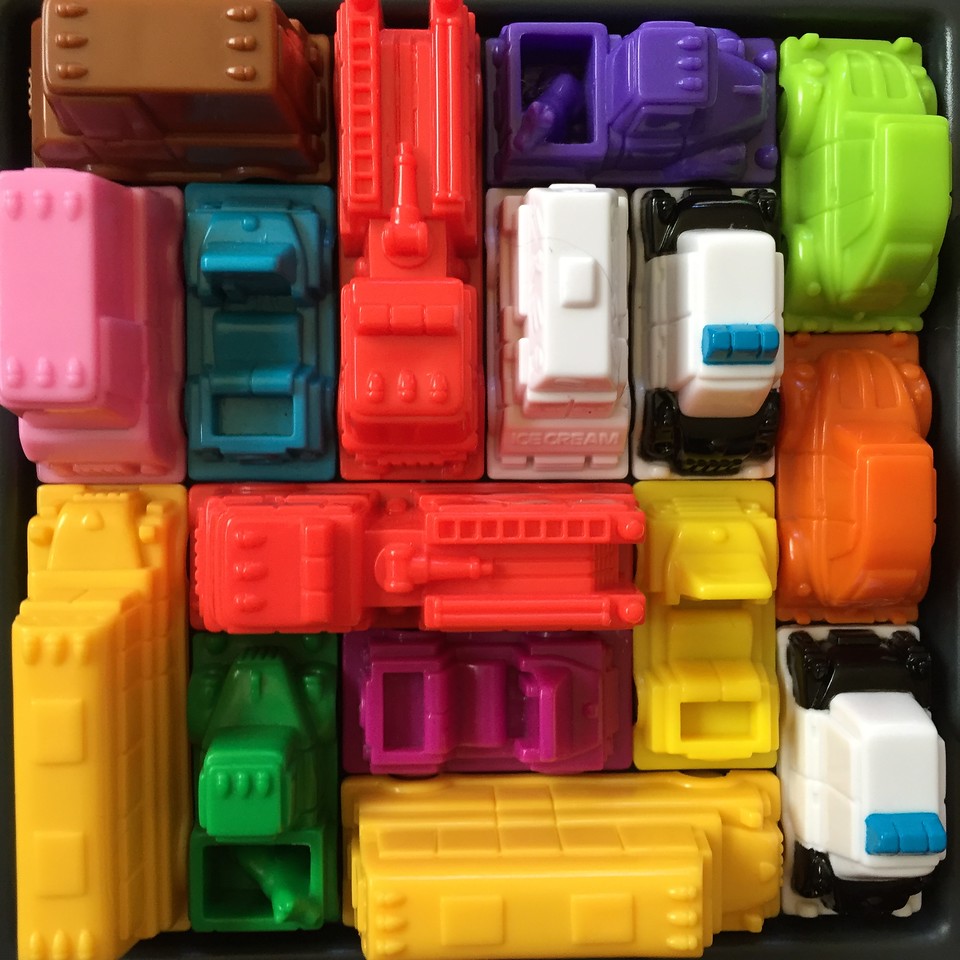 Rush Hour Junior STEM Kids logic game close up of brightly colored plastic vehicles
