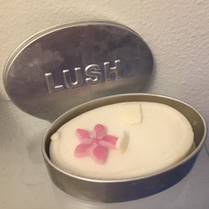 LUSH Solid massage bar in Tender Is the Night in open silver oval case