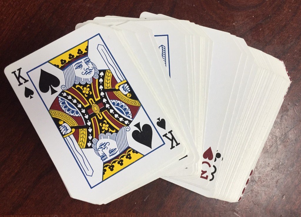 Deck of cards shuffled and fanned out on table