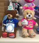 Build-A-Bear Birthday bears dressed in t-shirts and hats at store