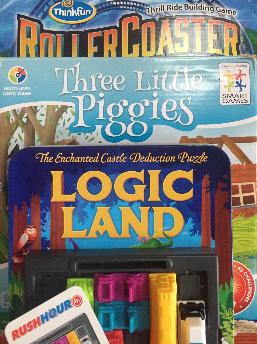 Logic puzzles for kids Roller Coaster Challenge Three Little Piggies Logic Land Castle and Rush Hour Jr in stack