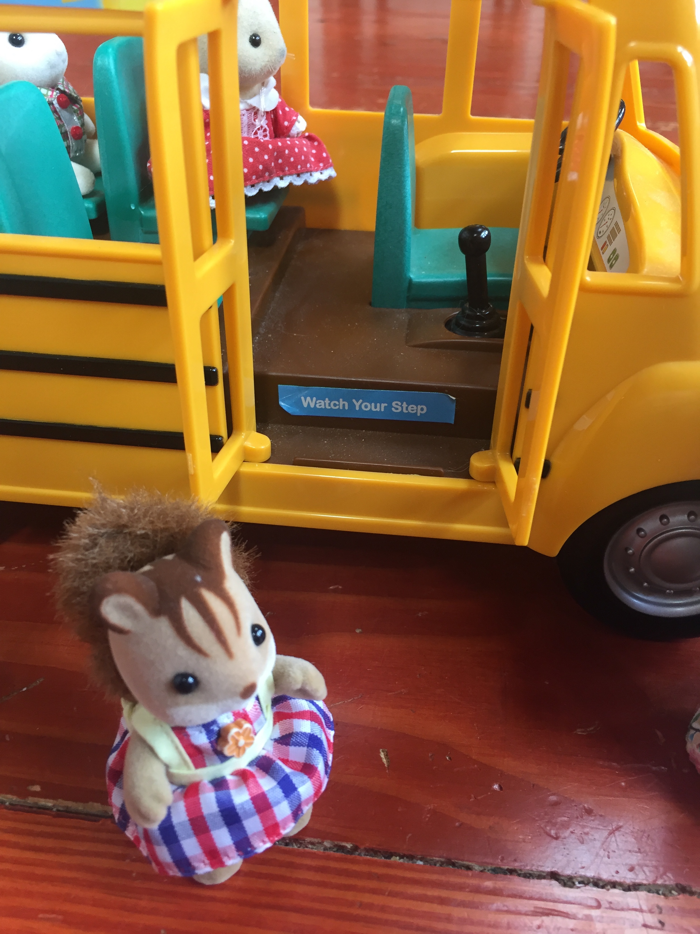 Calico Critters School Bus with door open and kid squirrel waiting to get on