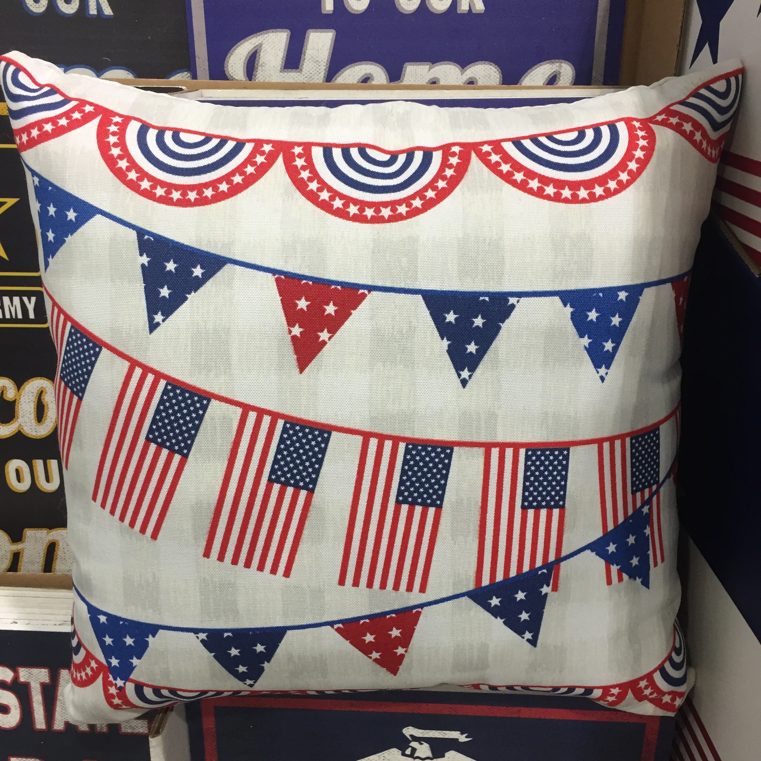 Festive pillow covered in American flags and red white and blue bunting for Fourth of July