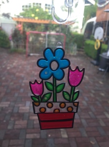 Make Your Own Suncatchers Window Art flowers in flower pot hanging on door window to patio