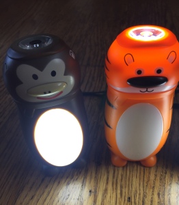 Animal shaped LED flashlight lanterns belly and head lit up on monkey and tiger