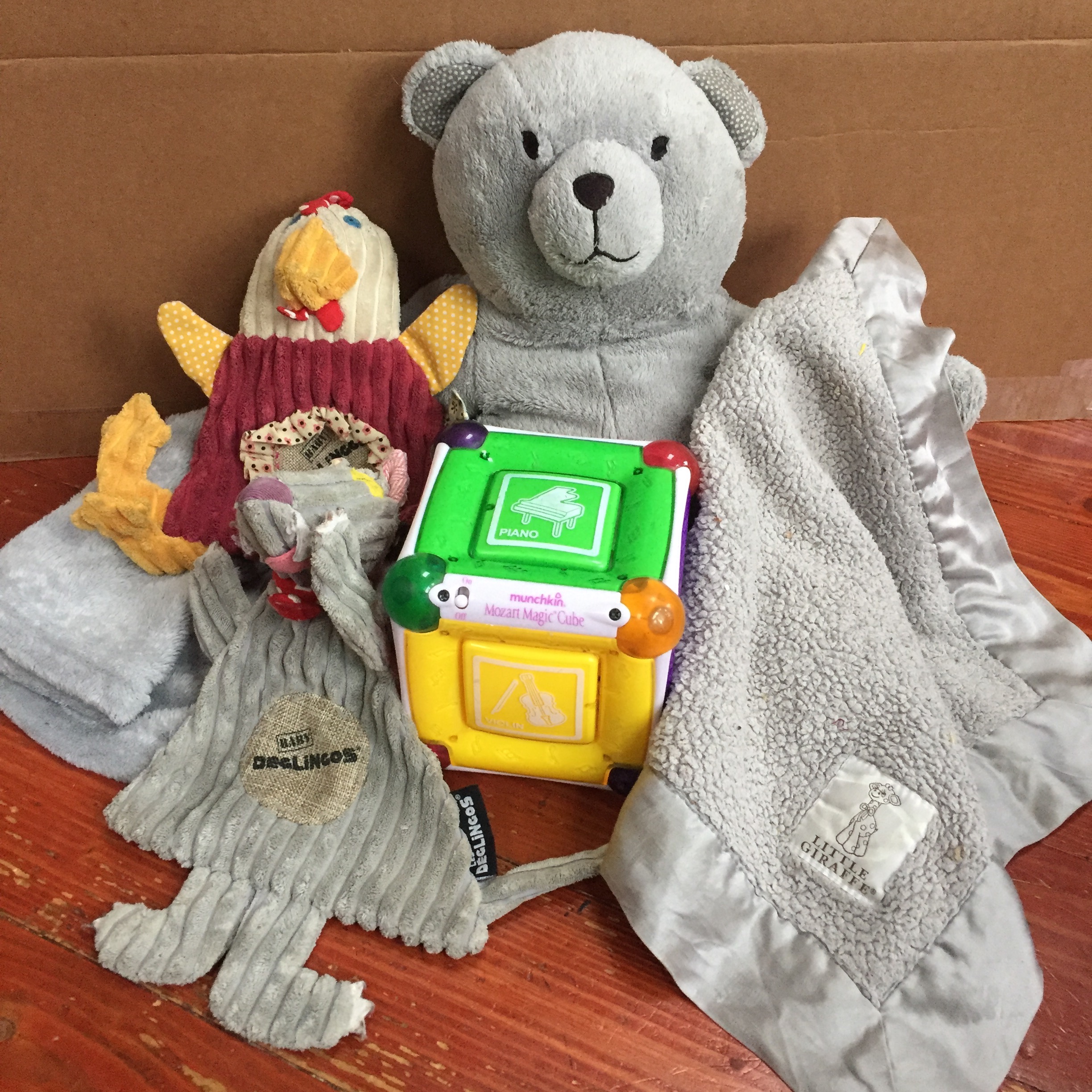 Infant Gift Guide Over $20 Deglingos Baby Animals, Mozart Music Cube, Blanket Bear Buddy, Little Giraffe gray baby blanket