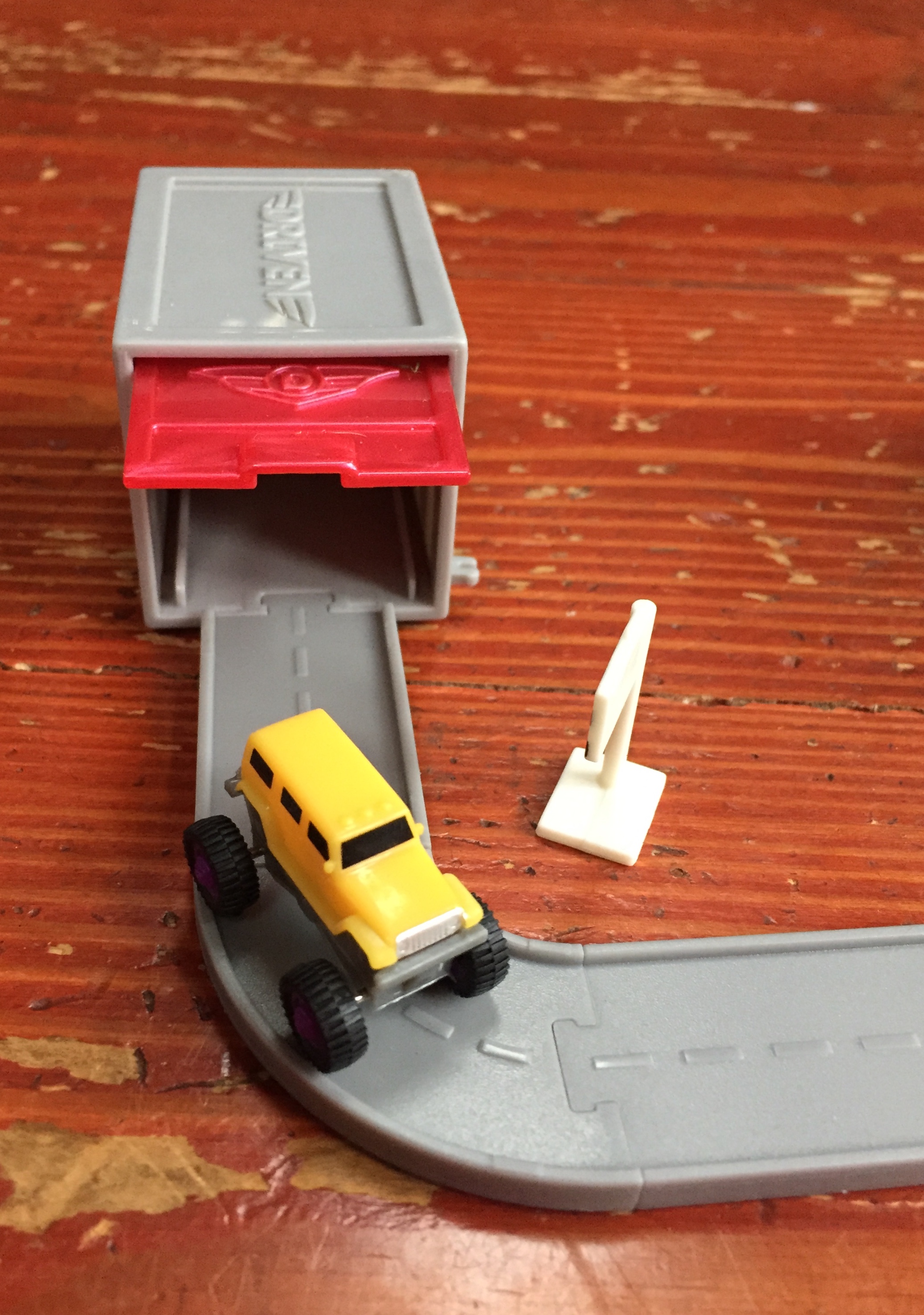 Driven Pocket Series 3 tiny garage with yellow truck with monster wheels