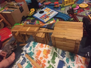 House and bridge and fort built from Lincoln Log type toy