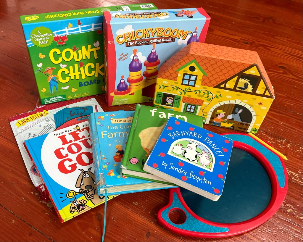 Gifts for farm-loving kids Count Your Chickens game, ChickyBoom game, Janod Story Box farm, Let's Count Goats, Boogie drawing board and farm accessory pack, Farm Tales book, farm board book, Barnyard Dance board book
