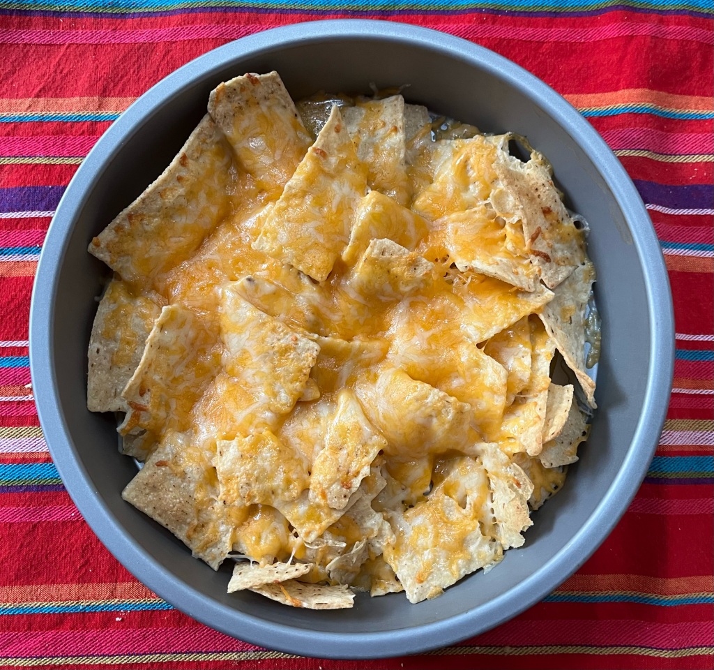 Kid nachos tortilla chips with melted cheese in cake layer pan