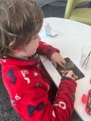 Seven year old using chalkboard crayons in airport lounge