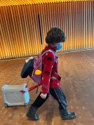Seven year old boy pulling JetKids BedBox through airport