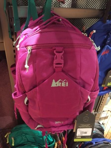 REI Kids' backpack in hot pink on rack at store