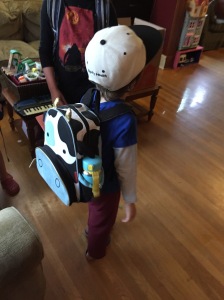 Child wearing cow Skip Hop Zoo backpack