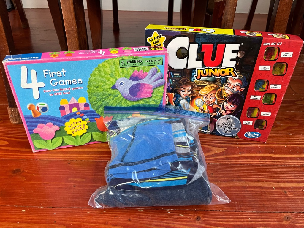 Packing spare clothing for kids in Ziploc bag, Four First Games in one box, Clue Junior board game for kids