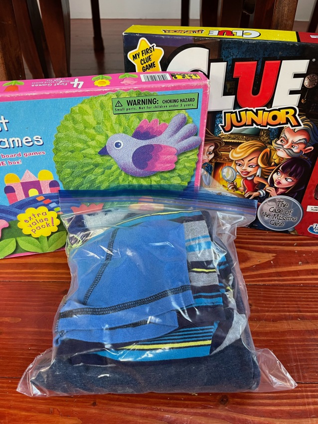 Packing spare clothing for kids in Ziploc bag, Four First Games in one box, Clue Junior board game for kids