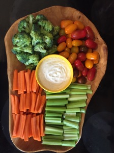 homemade veggie tray snack time platter with carrots, celery, broccoli, and cherry tomatoes with ranch dressing in the middle