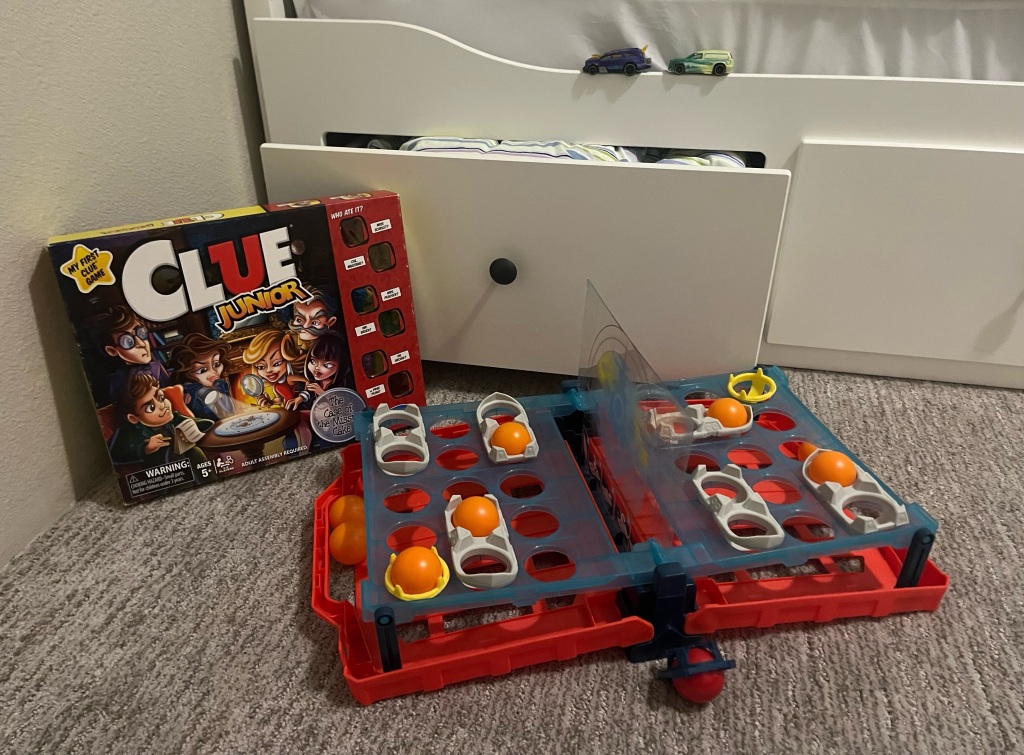 Hemnes convertible daybed, Clue Junior game, Battleship Shots game, and changing color Hot Wheels