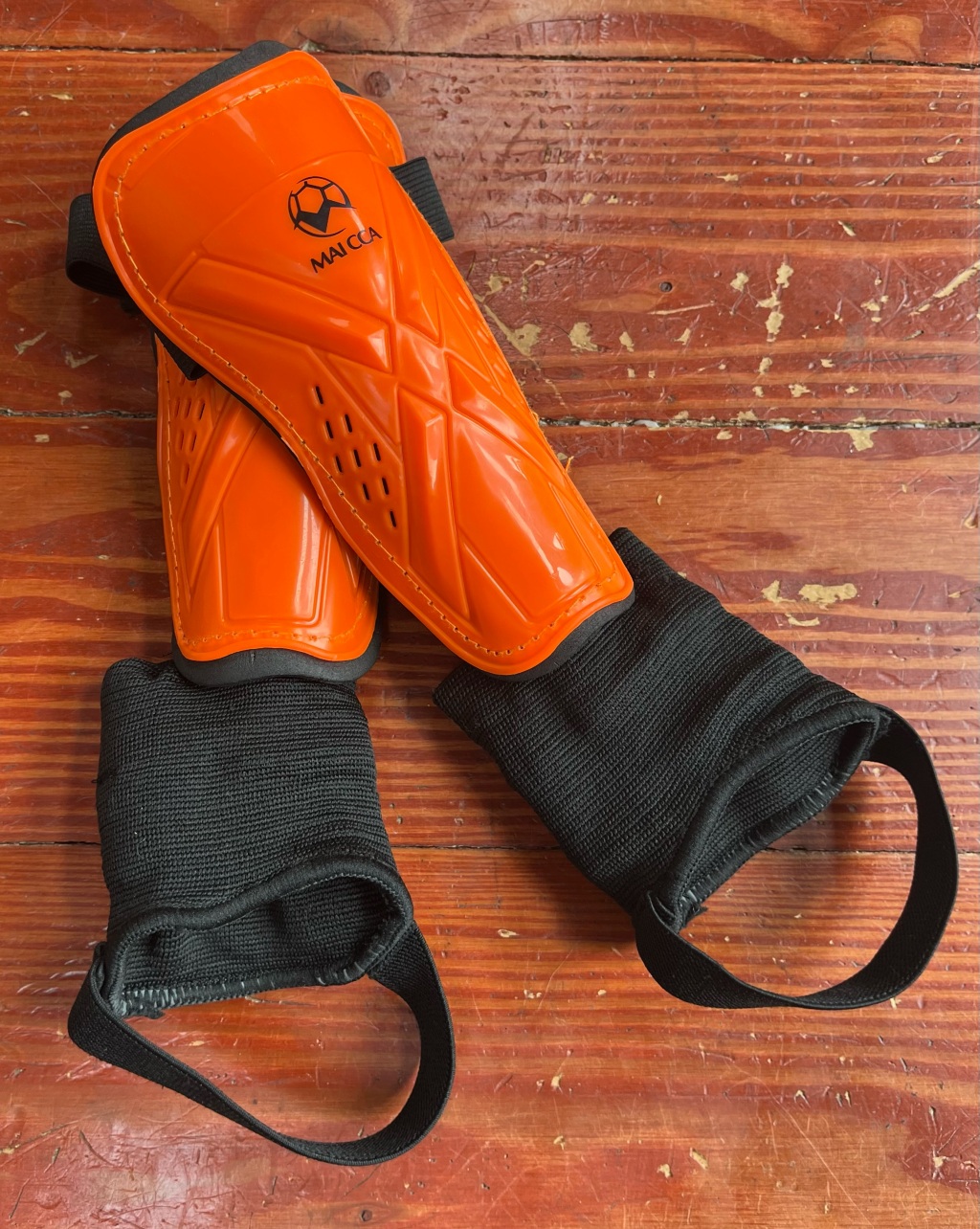 Outfun Youth Soccer Shin Guards on orange and black